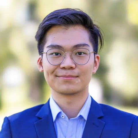 Hao Jun, smiling, in a blue blazer